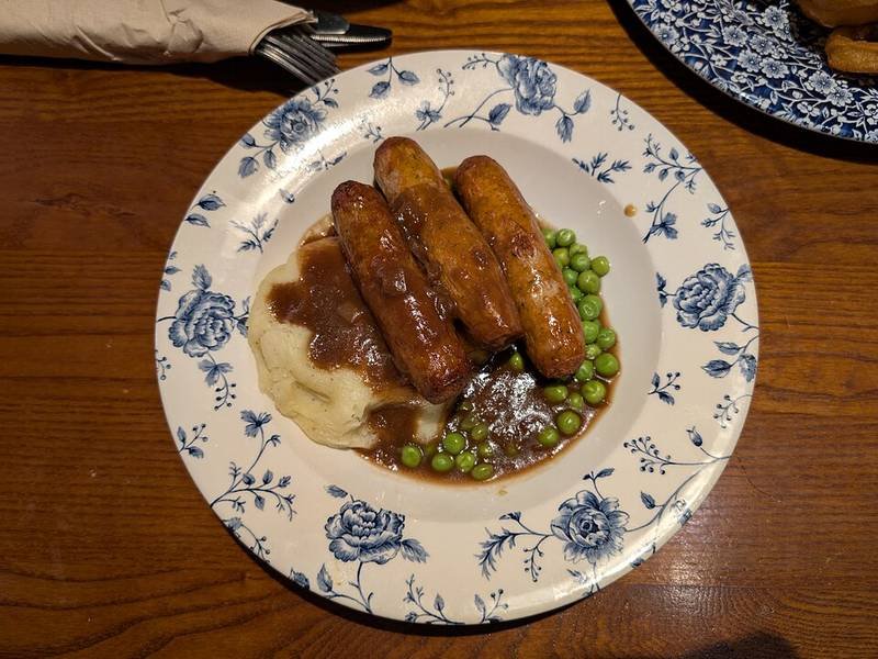 Bangers and Mash with Onion Gravy — British dinner recipe, served and ready to eat